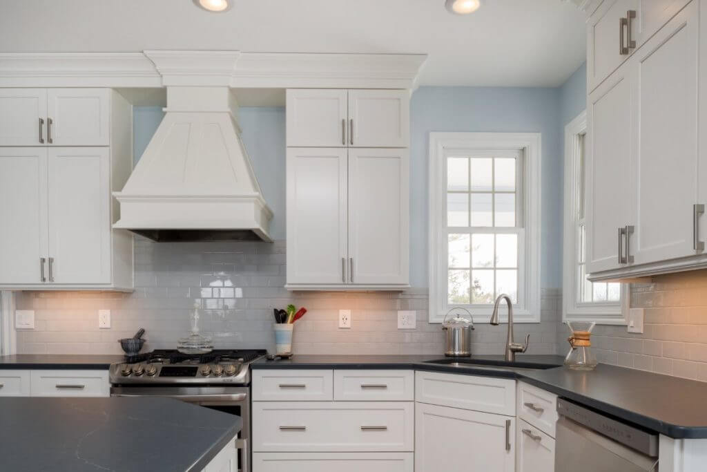 White kitchen cabinets with undercabinet lighting