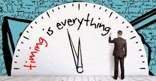 Timing-is-Everything Man writing Timing is Everything on a giant clock